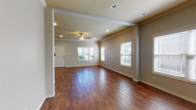 Unfurnished room with ornamental molding, dark woo