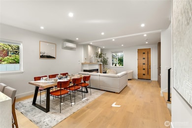 Great room with the dining area in the middle. To the middle right the staircase.