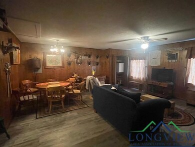 Living area with wood finished floors, wooden wall