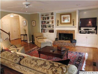 Spacious den with arched entry