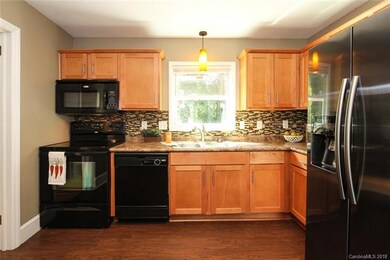 Kitchen is well lit and overlooks the large fenced
