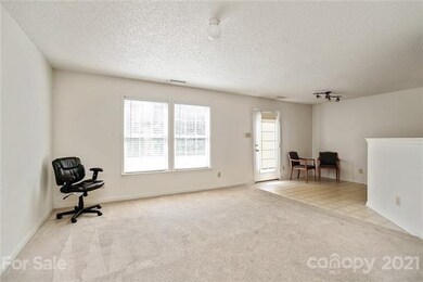 Living room with view to dining area. These window