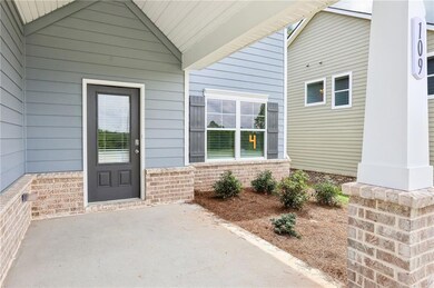Doorway to property featuring brick siding and a patio area