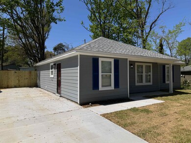 View of front of property featuring roof with shingles and concrete driveway