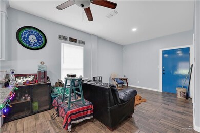 Living room with ceiling fan, wood finished floors, and recessed lighting