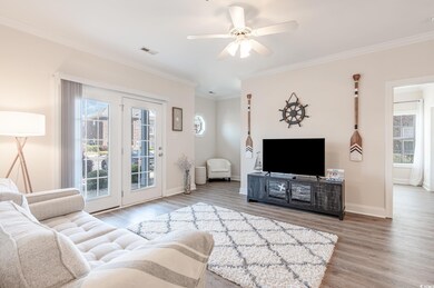Living room featuring visible vents, baseboards, a
