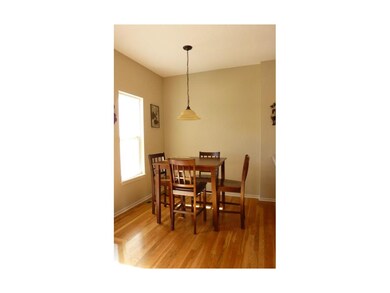 Wood floors continue from the kitchen into the din