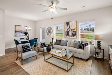 Living room featuring dark wood-style floors, a chandelier, and ceiling fan