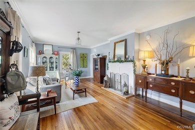 Living room featuring ornamental molding, a brick