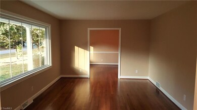 Spacious living room with large picture window! Hardwoods continue.