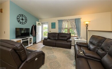 Hardwood floored living room with vaulted ceiling