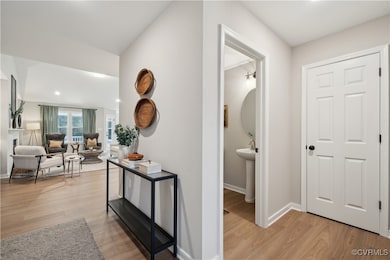 Corridor with baseboards and light wood-style floo