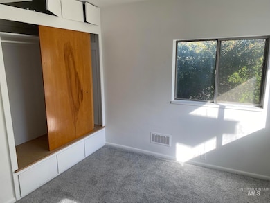 Unfurnished bedroom featuring carpet flooring and a closet