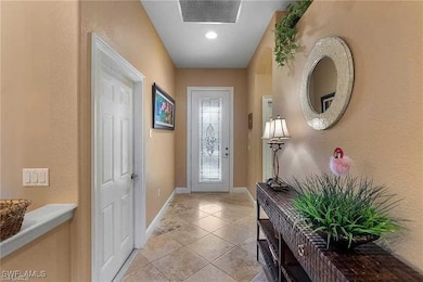 Entryway with baseboards, visible vents, a texture
