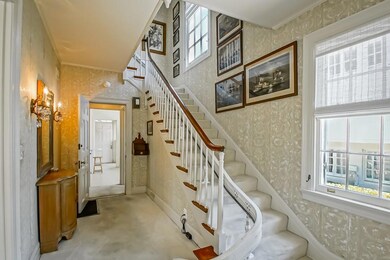 A gracious staircase welcomes family and friends.