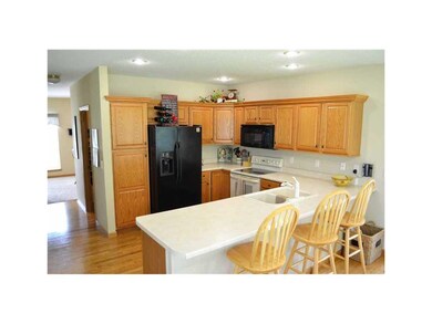 Kitchen. Hardwood floors, breakfast bar, all appli
