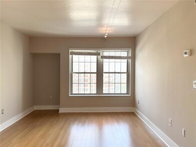 Spare room featuring light wood-style floors and baseboards