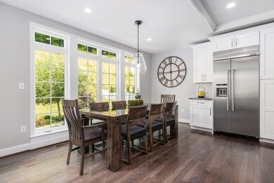 This large eating area is flooded with light from the large windows with transoms.