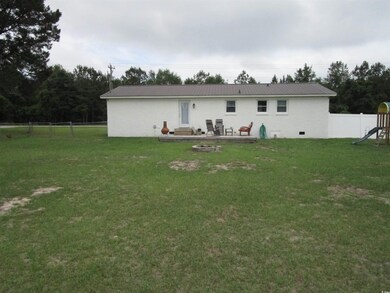Back of house featuring a playground and metal roof