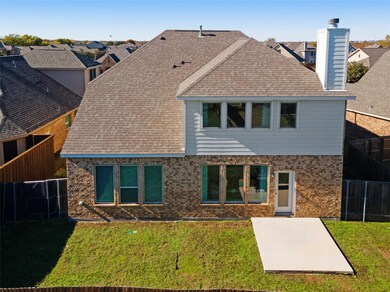 Rear view of house featuring a patio area and a ya