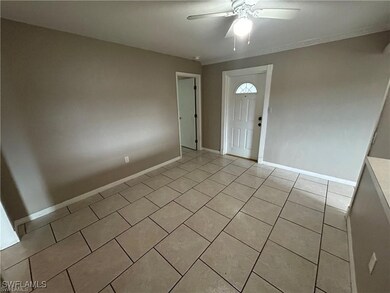 Foyer with light tile patterned floors and ceiling