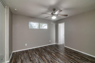 Unfurnished room with dark wood-type flooring, a t