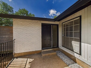 Doorway to property featuring brick siding