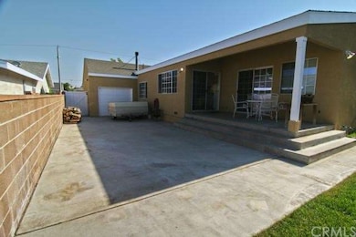 Rear garage door on tandem side of garage allows for storage on concrete pad in back yard area