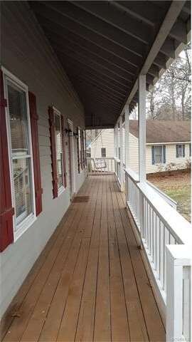 Full country porch and the swing conveys.