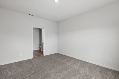 Carpeted empty room with baseboards