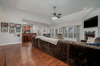 Spacious Den with updated flooring, elevated ceilings, a fireplace, and views for days!