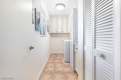 Laundry area with light tile patterned floors, was