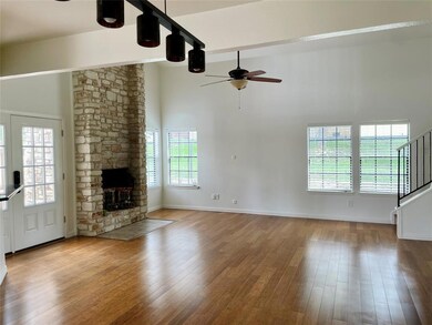 Unfurnished living room featuring a ceiling fan, 