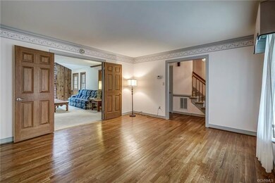 Living room with beautiful hardwood floors, crown 