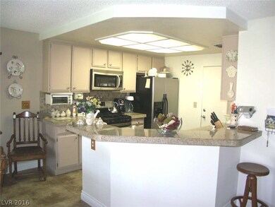 Kitchen with granite tile counters, tile backsplas