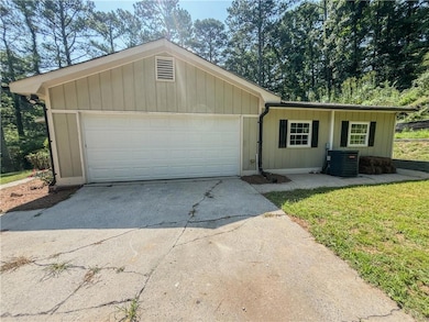 Ranch-style house featuring concrete driveway and a garage