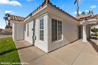 View of home's exterior featuring stucco siding and a tiled roof