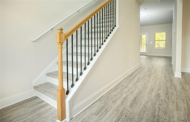 Staircase with hardwood / wood-style floors