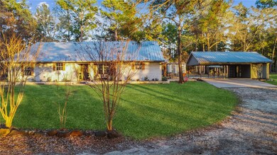 Ranch-style house featuring a front yard and a car