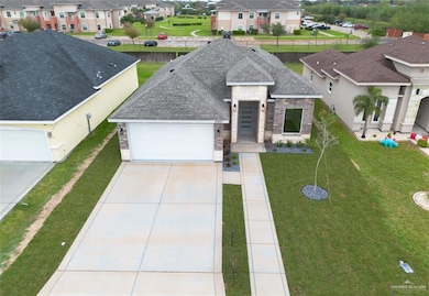 View of front facade with a garage and a front lawn