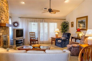 Large Bright Living Room with Ceiling Fan and Entry to Screened Porch