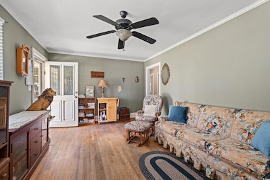 Living area with baseboards, ornamental molding, w