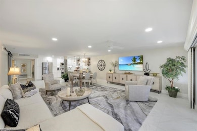 Living area with recessed lighting and a chandelier