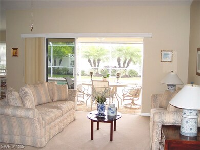 OPEN FLOOR PLAN WITH SLIDERS LEADING TO THE COVERED LANAI