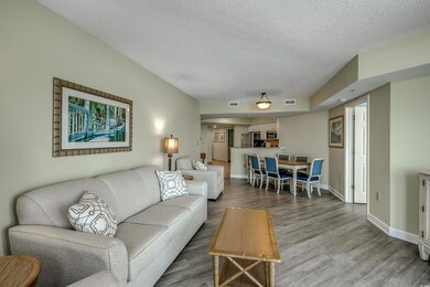 Living area with visible vents, baseboards, a text