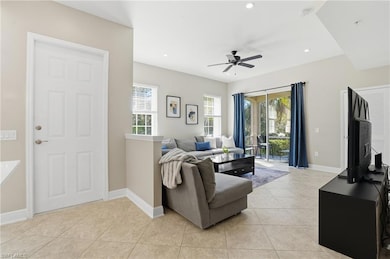 Living room with light tile patterned floors, recessed lighting, and ceiling fan