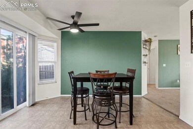 Dining area featuring ceiling fan and light carpet