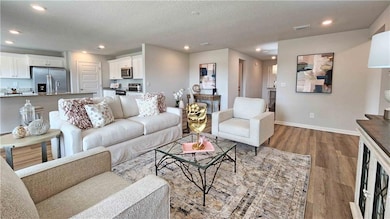 Living area featuring a textured ceiling, baseboar