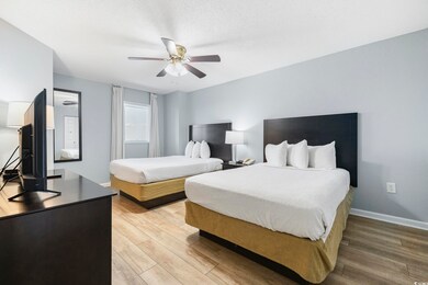 Bedroom featuring light hardwood / wood-style floo