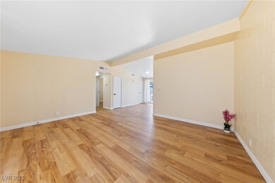Unfurnished living room with light wood-style floo